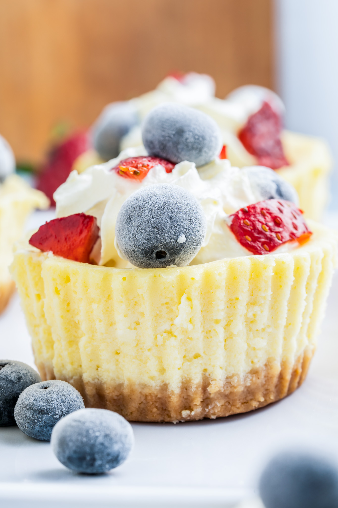 prepared cheesecake topped with whipped cream and berries