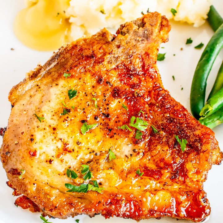 golden brown pork chop on white plate